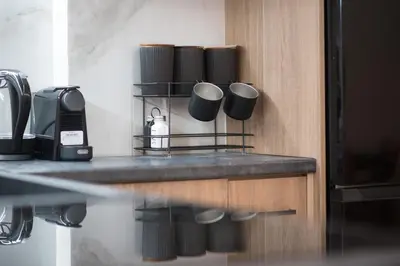 a kitchen with a counter with cups on it at Stylish & Elegant Apt in Pagrati in Athens