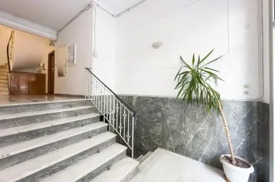 a plant in a pot sitting on the stairs in a building at Stylish & Elegant Apt in Pagrati in Athens