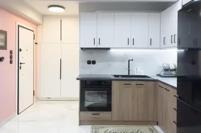 a kitchen with white cabinets and a sink at Stylish & Elegant Apt in Pagrati in Athens
