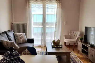 a living room with a couch and a tv at Cozy Athenian 2BD Apt Top Floor Panoramic View in Athens