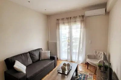a living room with a couch and a table at Cozy Athenian 2BD Apt Top Floor Panoramic View in Athens