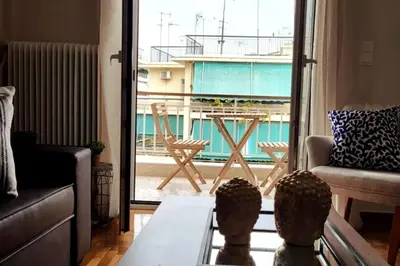 a living room with a view of a balcony at Cozy Athenian 2BD Apt Top Floor Panoramic View in Athens