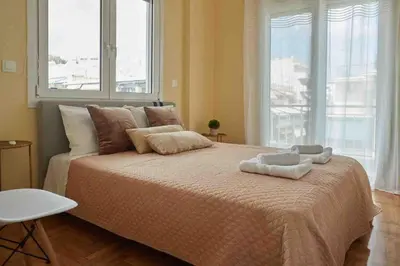 a bedroom with a large bed with two towels on it at Cozy Athenian 2BD Apt Top Floor Panoramic View in Athens