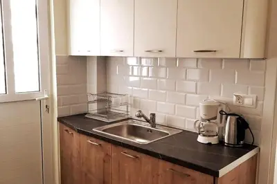 a kitchen with a sink and a counter top at Cozy Athenian 2BD Apt Top Floor Panoramic View in Athens