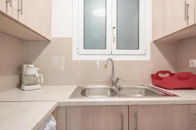 a kitchen counter with a sink and a window at Cozy Acropolis Studio in the heart of Athens in Athens