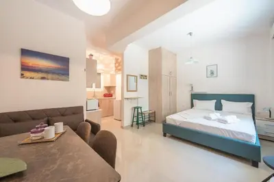 a bedroom with a bed and a living room at Cozy Acropolis Studio in the heart of Athens in Athens