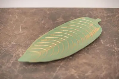 a green feather shaped object sitting on a table at Cozy Acropolis Studio in the heart of Athens in Athens