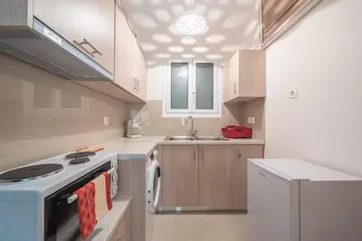 a kitchen with a stove and a sink at Cozy Acropolis Studio in the heart of Athens in Athens