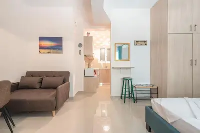 a living room with a couch and a bed at Cozy Acropolis Studio in the heart of Athens in Athens