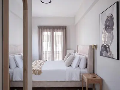 a white bedroom with a bed and a window at Sleek & Stylish 2 bd apt with Parthenon view in Athens
