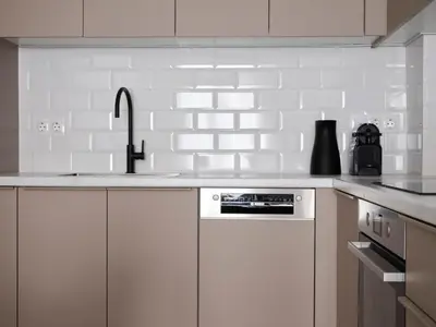 a white kitchen with a sink and a counter top at Sleek & Stylish 2 bd apt with Parthenon view in Athens