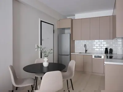 a kitchen with a table and chairs and a refrigerator at Sleek & Stylish 2 bd apt with Parthenon view in Athens