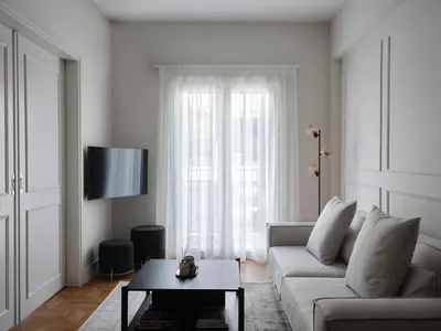 a living room with a couch and a window at Sleek & Stylish 2 bd apt with Parthenon view in Athens