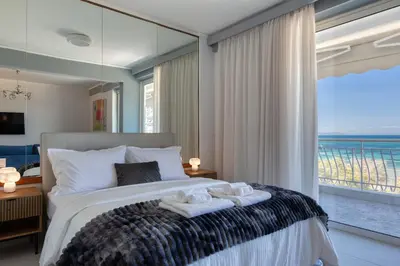 a bedroom with a large bed with towels on it at Luxury Beachfront Paradise in Athens Rivieria Kavouri Vouliagmeni in Athens