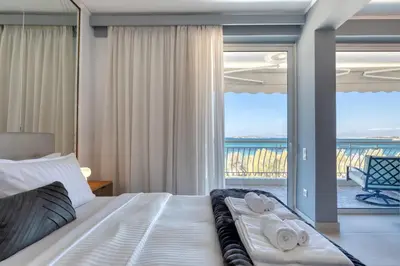 a bedroom with a bed with a view of the ocean at Luxury Beachfront Paradise in Athens Rivieria Kavouri Vouliagmeni in Athens