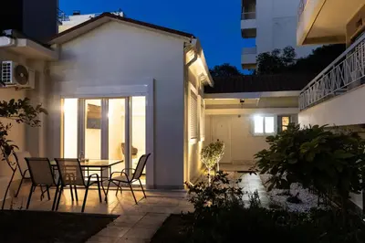 a patio of a house with a table and chairs at South Glyfada Downtown49 Apartment in Athens