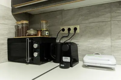 a coffee maker and a toaster on a kitchen counter at South Glyfada Downtown49 Apartment in Athens