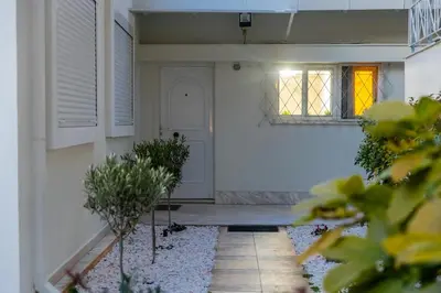 a hallway of a home with a white door and windows at South Glyfada Downtown49 Apartment in Athens