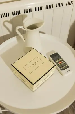 a book and a remote control sitting on a table at South Glyfada Downtown49 Apartment in Athens