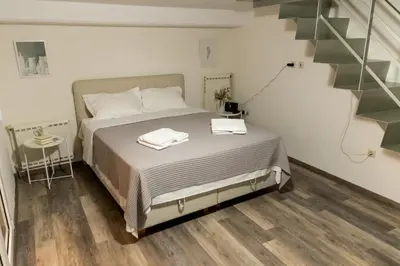 a bedroom with a bed with two towels on it at South Glyfada Downtown49 Apartment in Athens