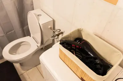 a bathroom with a toilet and a box of tools at South Glyfada Downtown49 Apartment in Athens