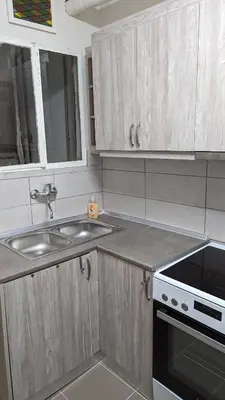 a kitchen with a sink and a stove at Acropolis View Condo, perfect location! in Piraeus