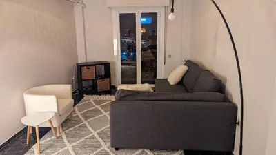 a living room with a couch and a chair at Acropolis View Condo, perfect location! in Piraeus