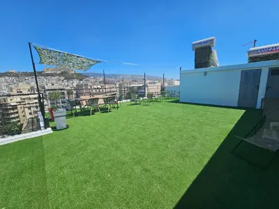 a patio with green grass on the roof of a building at Lycabettus View Kaniggos in Athens
