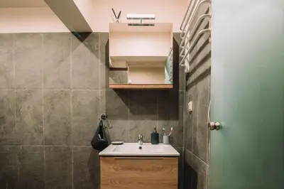 a small bathroom with a sink and a mirror at Lycabettus View Kaniggos in Athens
