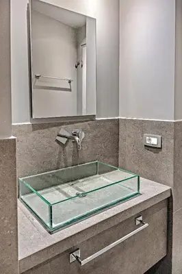 a glass sink in a bathroom with a mirror at Thissio Acropolis Historic Flat 1 in Athens