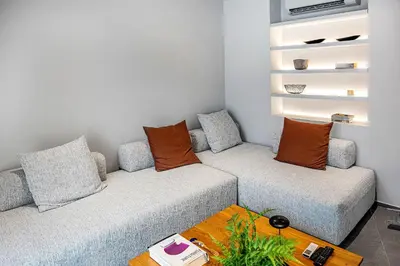 a living room with two couches and a table at Thissio Acropolis Historic Flat 1 in Athens