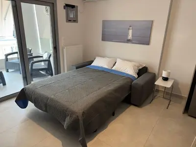 a bedroom with a bed with a lighthouse on the wall at Central Apartment with private parking in Athens