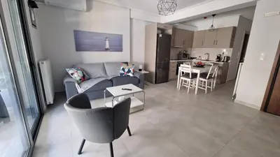 a living room with a couch and a table at Central Apartment with private parking in Athens
