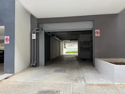 an empty parking garage with exit signs on the wall at Central Apartment with private parking in Athens