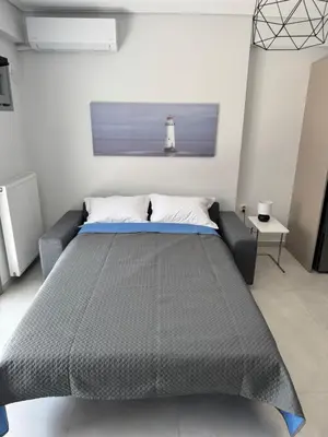 a bedroom with a bed and a lighted lighthouse at Central Apartment with private parking in Athens
