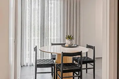 a dining room with a table and four chairs at Thissio Acropolis Historic Flat 2 in Athens