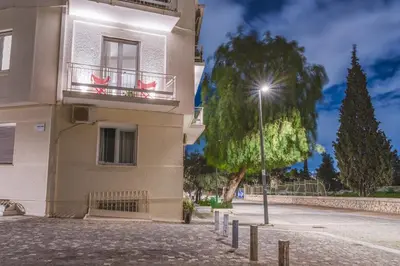 a building with a street light next to a tree at Thissio Acropolis Historic Flat 2 in Athens