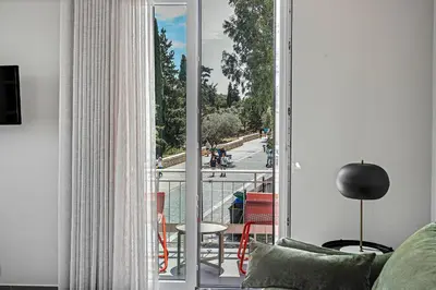 a room with a balcony with a view of a street at Thissio Acropolis Historic Flat 2 in Athens