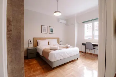 a bedroom with a bed and a desk and a table at Acanthus Art Deco Retreat 250 from Metro & Archaeology Museum in Athens