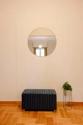 a black ottoman in a room with a mirror at Acanthus Art Deco Retreat 250 from Metro & Archaeology Museum in Athens