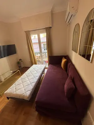 a living room with a couch and a window at Acanthus Art Deco Retreat 250 from Metro & Archaeology Museum in Athens