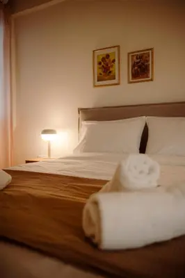a bedroom with a bed with two towels on it at Acanthus Art Deco Retreat 250 from Metro & Archaeology Museum in Athens