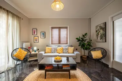a living room with a couch and a table at Comfy and calm apartment near the beach in Athens
