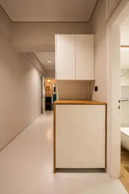 a room with a white cabinet and a hallway at Comfy and calm apartment near the beach in Athens