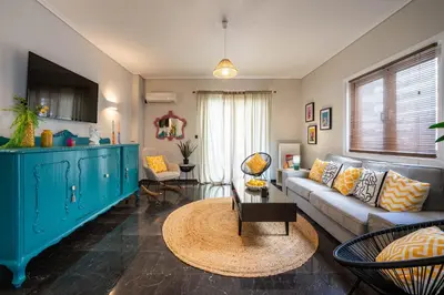 a living room with a couch and a table at Comfy and calm apartment near the beach in Athens
