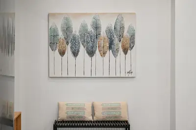 a picture of feathers hanging on a wall at Luxury Apartment for 5 Ppl in the Center of Athens in Athens