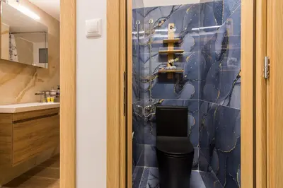 a bathroom with a blue tiled wall at Luxury Apartment for 5 Ppl in the Center of Athens in Athens