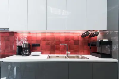 a kitchen counter with a sink and red tiles at Luxury Apartment for 5 Ppl in the Center of Athens in Athens