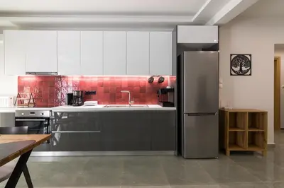 a kitchen with a stainless steel refrigerator and red tiles at Luxury Apartment for 5 Ppl in the Center of Athens in Athens