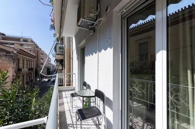 a balcony with a chair and a window at Luxury Apartment for 5 Ppl in the Center of Athens in Athens